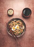Buckwheat noodles, soba, with shimeji mushrooms, boiled egg, green onion, sesame seeds, homemade, no people [IBR124585363]