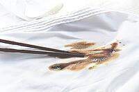 White shirt stained with soy sauce and chopsticks lying on it, no people, close-up, selective focus [IBR124585373]