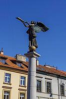 Angel statue with trumpet on a pillar against a blue sky, Vilnius, Lithuania, Baltic States [IBR124586568]