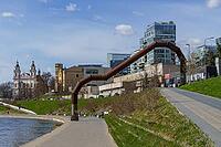 Modern and historic buildings along a river with large pipes along the waterfront, Vilnius, Lithuania, Baltic States [IBR124586573]