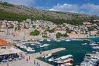 Dubrovnik, Croatia-12.09.2024: Panoramic view of Dubrovnik Old Harbor with white boats on the Adriatic Sea, surrounded by medieval city walls [IBR124586585]