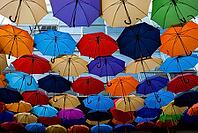 Vibrant colorful umbrella installation against urban backdrop - artistic overhead display [IBR124626831]