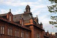 Helsinki, Finland - June 21, 2015 - Historic gothic architecture of red brick building with tower and ornaments under blue sky [IBR124626834]
