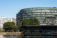 Helsinki, Finland - June 21, 2015 - Modern office building with glass facade by waterfront on sunny day [IBR124626837]