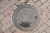 Helsinki, Finland - August 28, 2014 - Helsinki manhole cover on cobblestone street [IBR124626857]