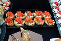 A selection of elegant canapés topped with smoked salmon, capers, and cream cheese. perfect for catering at events or sophisticated gatherings, offering a taste of luxury [IBR124626889]