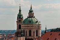 Prague, Czech - August 22, 2013 - St. nicholas church dome and clock tower in prague's skyline under blue sky [IBR124626900]