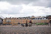 Helsinki, Finland - August 28, 2014 - Busy city square with historic european architecture under cloudy skies [IBR124626903]
