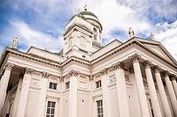 Helsinki, Finland - August 28, 2014 - Iconic white cathedral with columns and statues against blue sky in helsinki [IBR124626907]