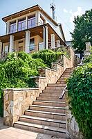 Kolomna, Russia - August 17, 2014 - Elegant modern house with stone staircase and lush greenery [IBR124626908]
