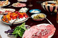 A vibrant spread featuring a variety of italian appetizers and antipasto. fresh vegetables, assorted meats, cheeses, and olives are artfully arranged to delight the senses [IBR124626913]