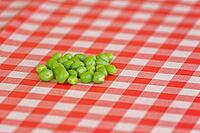 Peas (Pisum sativum) on a tablecloth, Loureira, Leiria district, Centro region, Portugal [IBR124629045]