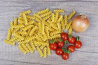 Onions (Allium cepa) with cocktail tomatoes (Solanum lycopersicum) and fusilli pasta, Kempen, North Rhine-Westphalia, Germany [IBR124629095]