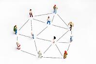 People miniature figurines connected, as concept for social networking [IBR124629569]