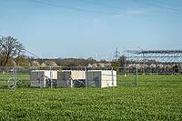 Counterweights for power line construction with wind turbines and cable bridge in the background, Hoya, Lower Saxony, Germany [IBR124631253]