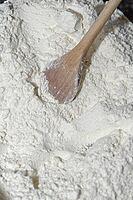Wheat flour (Triticum aestivum) with wooden spoon, Krefeld, North Rhine-Westphalia, Germany [IBR124631260]