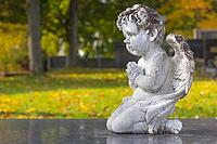 Sculpture of a little angel on a tomb in cemetery. Graz, Austria [IBR124636286]