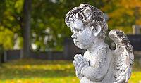 Sculpture of a little angel on a tomb in cemetery. Graz, Austria [IBR124636287]