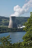 Nuclear power plant in Leibstadt with cooling tower and steam clouds, steam clouds over the nuclear power plant cooling turn, energy generation plant with nuclear power plant, nuclear power plant cooling tower between trees with steam clouds and power pol [IBR124636294]
