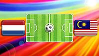A vivid football matchup illustration with a central green pitch and ball, flanked by Netherlands and Malaysia flags. The radiant multicolor background conveys motion, excitement, and international rivalry in a bold, modern sports scene. created using gen [IBR124641994]