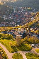 Aerial view of a settlement with traditional houses surrounded by green hills and sunlight, Calw District Office, Calw District, Germany [IBR124642835]