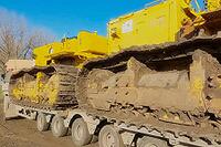 Pipelayers with removed booms on a truck with a special platform for transporting special equipment [IBR124748920]