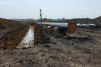 Laying pipelines in a ditch with the help of pipelayer loaders, construction of oil pipelines and gas pipelines in remote areas [IBR124748921]