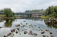 View of Ahvenkoski highway bridge over rocky rapids of the Kymijoki river in cloudy autumn weather, Pyhtää, Finland [IBR124748939]
