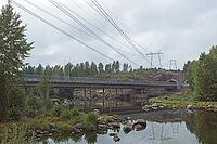 View of Ahvenkoski highway bridge over rocky rapids of the Kymijoki river in cloudy autumn weather, Pyhtää, Finland [IBR124748941]