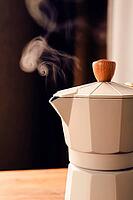 Geyser coffee maker, beige, close-up, boiling, steam from the spout, morning, breakfast, no people [IBR124748952]