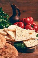 Georgian sliced cheese, on a wooden chopping board, with tomatoes with herbs and lavash, rustic style, Georgian cuisine, no people [IBR124748954]