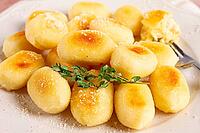 Stuffed gnocchi with cheese, Italian dumplings, garnished with parmesan cheese, no people [IBR124748988]