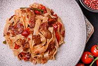 Food, Delicious asian udon dish with vegetables, meat, salt and spices on a ceramic plate on a dark concrete background [IBR124773702]