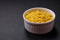 Food, Delicious boiled yellow rice with turmeric, salt and spices on a dark concrete background [IBR124773772]