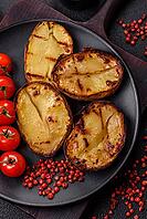 Food, Delicious potato halves in skins baked on the grill with salt, spices and herbs [IBR124773773]