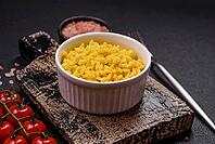 Food, Delicious boiled yellow rice with turmeric, salt and spices on a dark concrete background [IBR124773776]