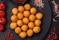 Food, Cheese or potato balls breaded with salt, spices and herbs. Fast food, junk food [IBR124773783]