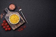 Food, Delicious boiled yellow rice with turmeric, salt and spices on a dark concrete background [IBR124773784]