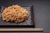Food, Asian dish rice noodles with salt and spices on dark concrete background [IBR124773787]