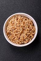 Food, Asian dish rice noodles with salt and spices on dark concrete background [IBR124773796]
