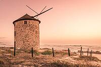 Old traditional wind-mill in sand-hills of Apulia Portugal [IBR124817868]