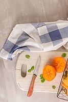 Delicious fresh persimmon fruit on kitchen countertop [IBR124817885]