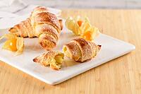 Small croissant with physalis fruits in white ceramic tray, homemade cakes on wooden table top [IBR124817892]