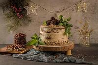Delicious naked coffee and hazelnuts cake on table rustic wood kitchen countertop [IBR124817893]