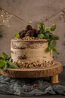 Delicious naked coffee and hazelnuts cake on table rustic wood kitchen countertop [IBR124817899]