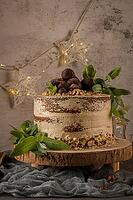Delicious naked coffee and hazelnuts cake on table rustic wood kitchen countertop [IBR124817903]