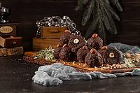 Dark chocolate truffles with hazelnuts over wooden cutting board [IBR124817915]
