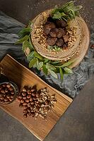 Delicious naked coffee and hazelnuts cake on table rustic wood kitchen countertop [IBR124817919]