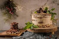 Delicious naked coffee and hazelnuts cake on table rustic wood kitchen countertop [IBR124817921]