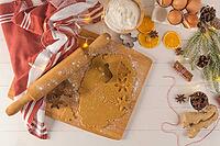 Raw dough for christmas cookies and cookie cutters on kitchen countertop [IBR124817923]